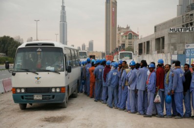 workmen queuing for bus